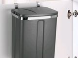 an image of a trash can in the corner of a kitchen