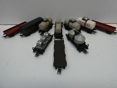 several toy trains are lined up on a white surface