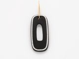 a close up of a black and white pendant on a white surface