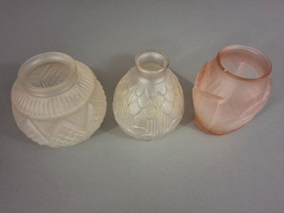 trois vases posés l'un à côté de l'autre sur une table
