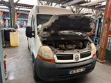 a white van with a hood open in a garage