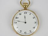 une montre de poche en or avec un cadran blanc sur une surface blanche
