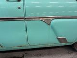 a blue car that is parked on the side of the street