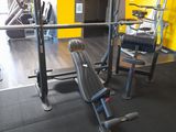 a gym with a bench, weights, and other equipment in the room