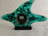 a green glass starfish on a black base