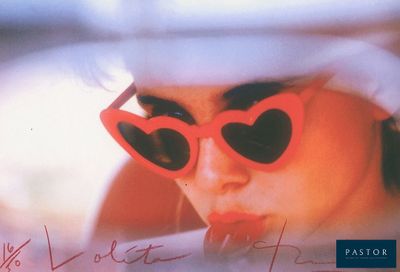 a picture of a woman wearing sunglasses and a hat