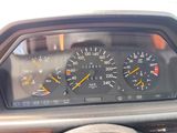 a close up of a car dashboard with a speedometer and gauges