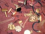 de nombreux objets en or et en argent posés sur un tissu rouge