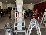 many ladders that are sitting in the middle of a room