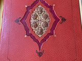 a red book that has a picture of a lion on it