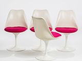 three white tulip chairs with pink cushions on a white surface