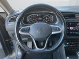 the interior of a car with a steering wheel and dashboard controls
