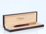 an image of a pen in a wooden box on a white surface