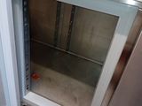 a small refrigerator with a glass door in a kitchen
