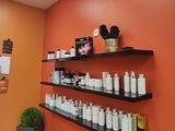 many bottles of hair products on the shelves in this room