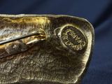 a close up of a gold belt with a metal buckle