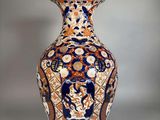 a vase with a design on it sitting on a table