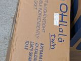 a box that is sitting on the ground next to a suitcase