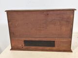 an old wooden box sitting on top of a white table