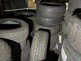 several tires are stacked on top of each other in a garage