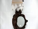 a lamp that has a mirror on it and a mirror on the wall