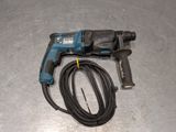a cord connected to an electric drill on a table