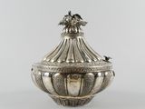 an antique silverplated sugar dish with a bird on top of it