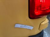 a close up of a yellow car with a sticker on it