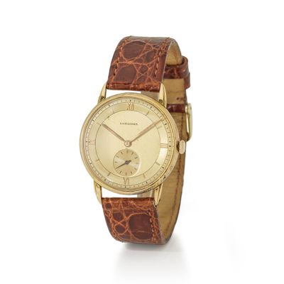 an image of a gold wrist watch with a brown leather strap