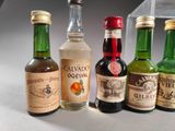 several bottles of liquor are lined up on a table