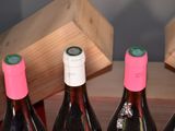 several bottles of wine are lined up in a row on a table