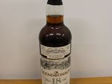 a bottle of liquor sitting on a wooden table