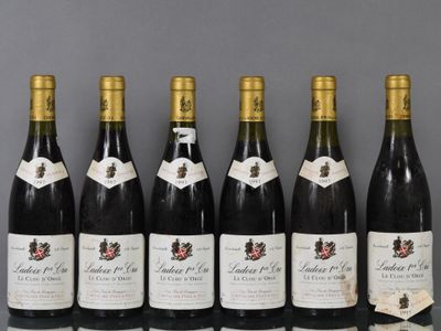 six bottles of wine are lined up in a row on a table