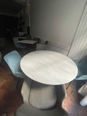 a table and chairs in a room with wood flooring