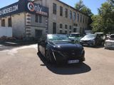 a black car parked in front of a building with a sign on it