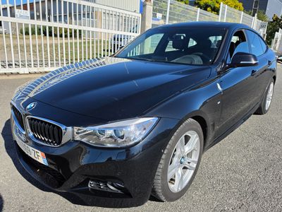 the bmw 3 series sedan is parked in front of a white fence