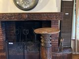 a clock on the wall above a fireplace in a living room