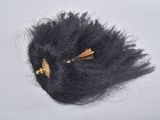 a black hair with a gold pin on top of it