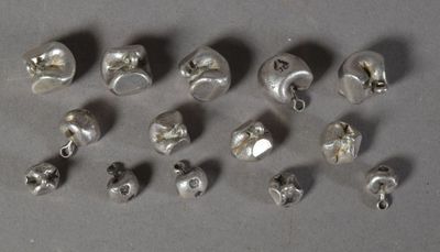a lot of silver beads that are on a table