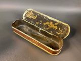 an old metal box with a handle sitting on top of a table
