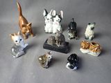 a lot of small figurines of cats on a table