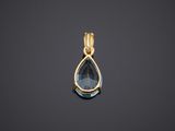 a gold pendant with a blue topaz stone