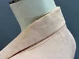 the back of a pink shirt with a white collar on a mannequin mannequin