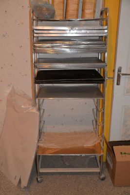 a metal shelf that has a bunch of pans on it