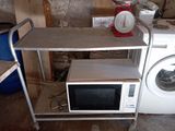 a microwave and a washing machine in a dirty room