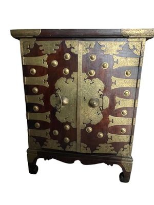 an image of a wooden cabinet with a gold and red design on it