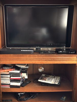 a television that is sitting on top of a book shelf