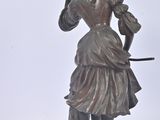 a statue of a woman holding a bird on a pedestal