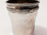 a silver cup that is sitting on a table