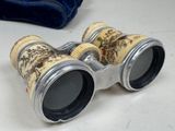 a pair of binoculars sitting on a table next to a bag